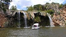 Boat under waterfall